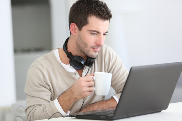 Man in front of laptop computer with headset-1