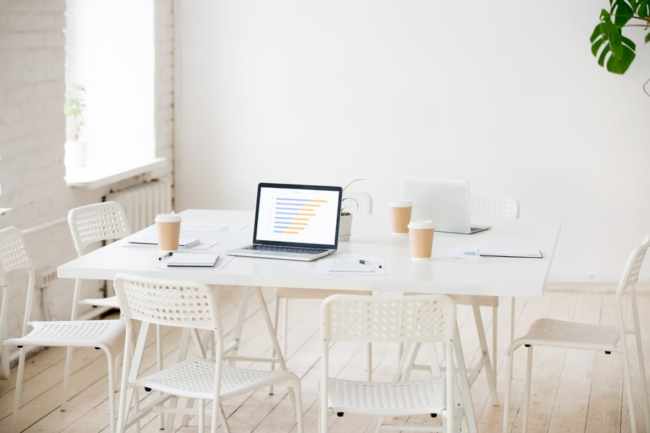 meeting-table-with-laptops-coffee-empty-office-room