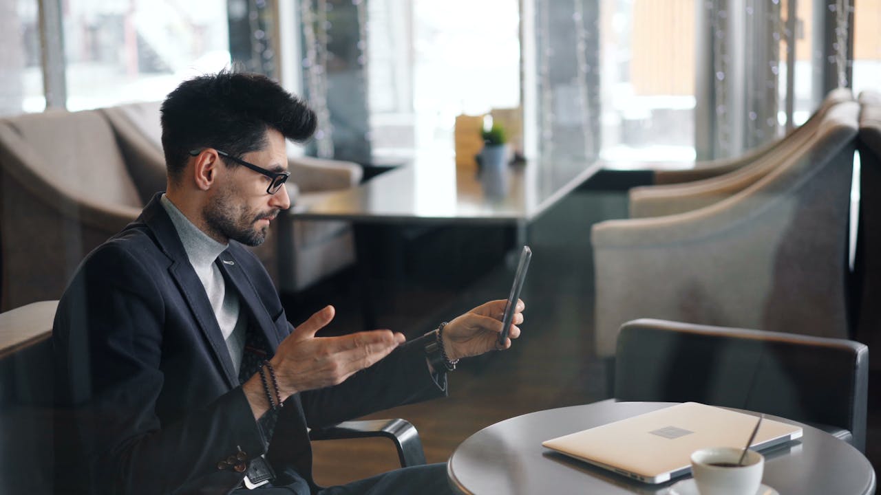 A man video conferencing with a smartphone