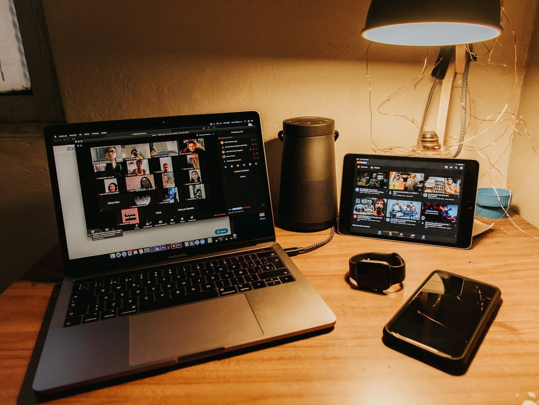 A home office with a laptop running Zoom