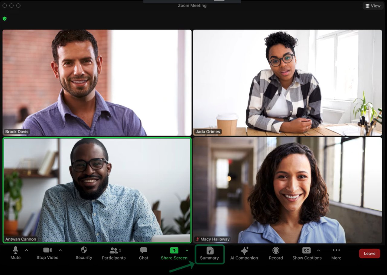 A laptop screen displaying a group of people in a virtual meeting