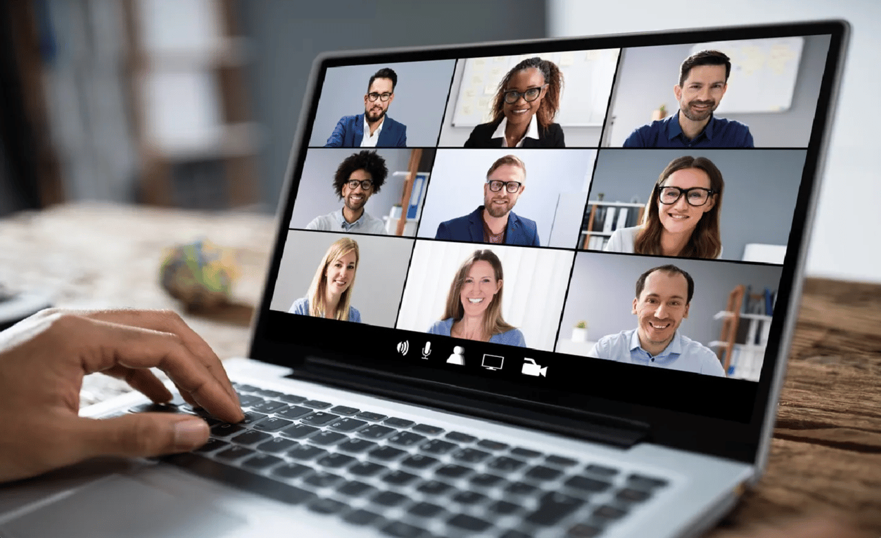 A woman meeting with a group of people in a video call